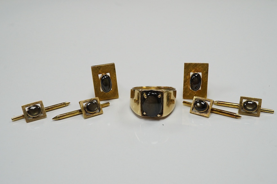 A pair of Chinese 14k and cabochon star sapphire set cufflinks, with four matching dress studs and ring, size X, gross weight 31.3 grams. Condition - fair to good